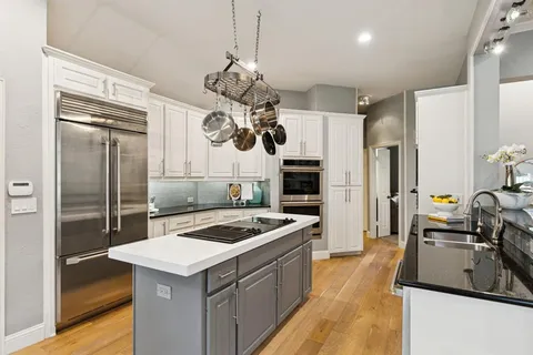 a kitchen with stainless steel appliances a stove sink and refrigerator