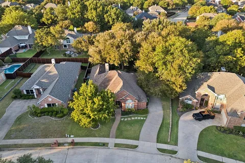 a view of backyard with swimming pool and seating space
