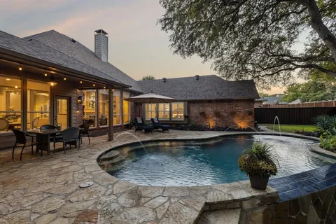 a view of a house with swimming pool and sitting area