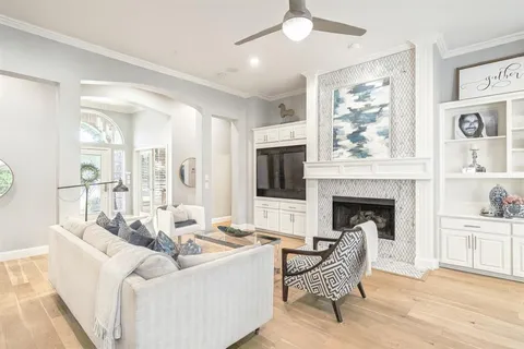 a living room with furniture a flat screen tv and a fireplace
