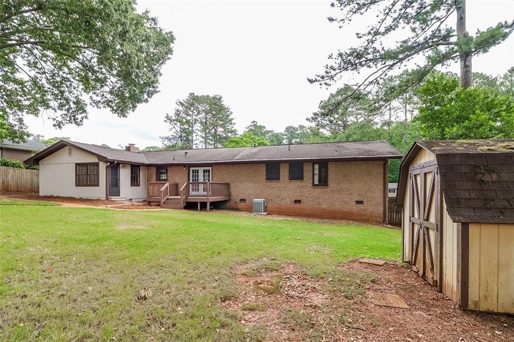1291 Stephens Street Southwest Lilburn, GA 30047 - Photo 8 of 22 a front view of house with yard barbeque and outdoor seating