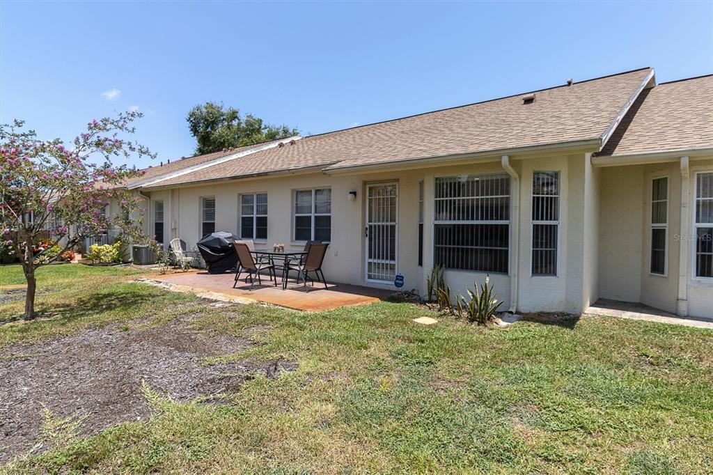 9052 Arundle Place New Port Richey, FL 34655 - Photo 23 of 57 a view of a house with porch and garden