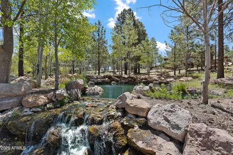 an aerial view of a house with outdoor space swimming pool and lake view