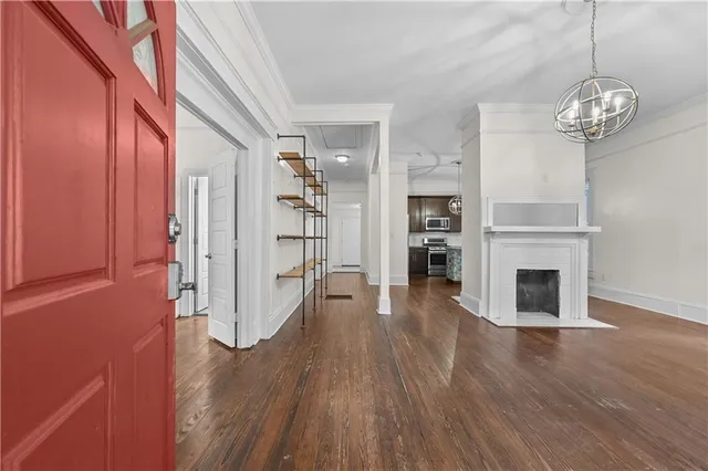a view of a livingroom with wooden floor and a fireplace