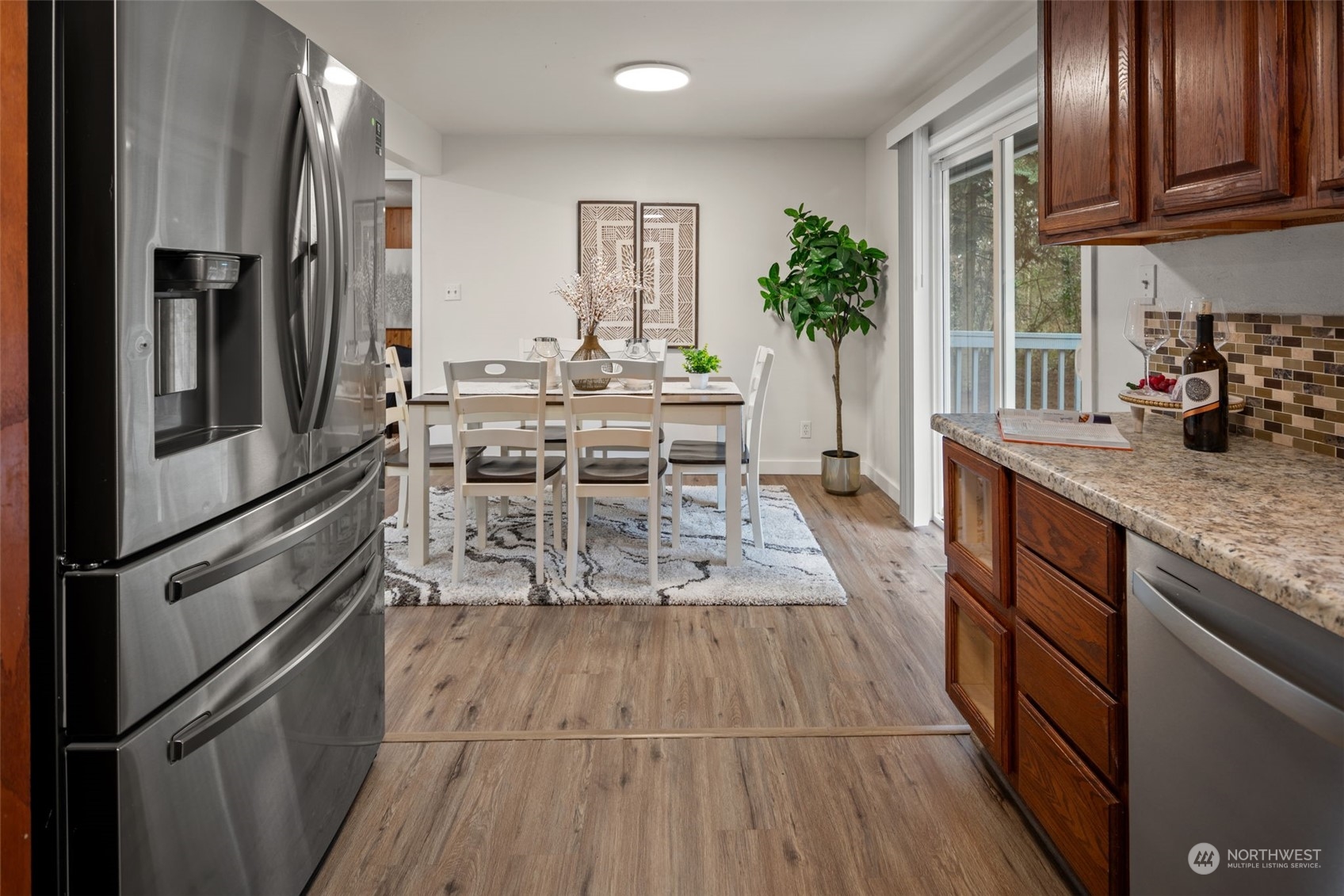 432 170th Place Southwest Bothell, WA 98012 - Photo 11 of 30 a kitchen with stainless steel appliances granite countertop a refrigerator a stove and a wooden floors