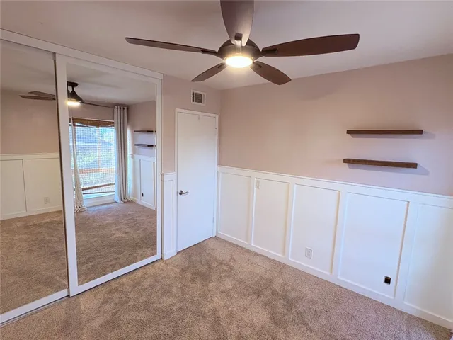 an empty room with a ceiling fan