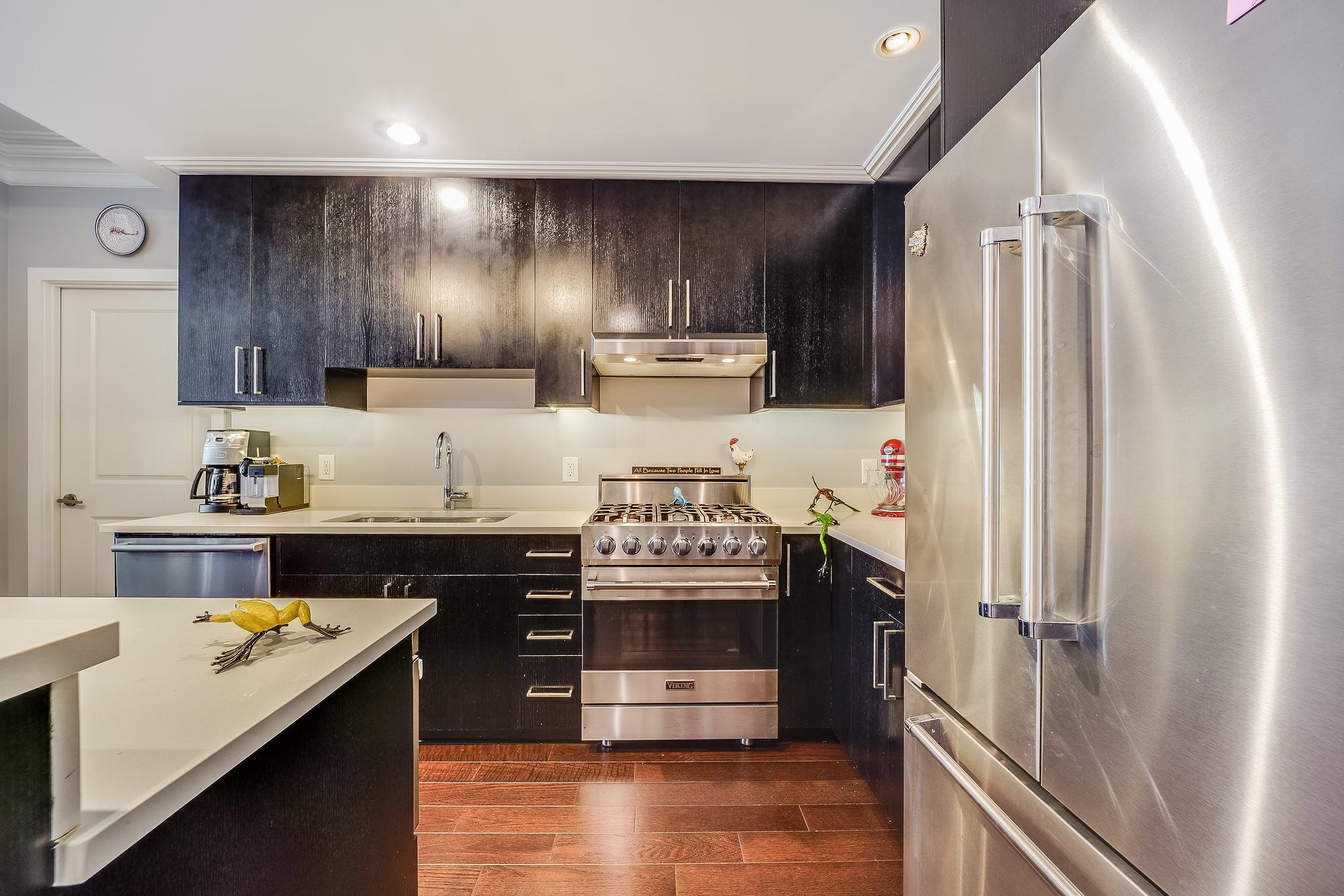 1100 Maxwell Lane, Unit 903 Hoboken, NJ 07030 - Photo 2 of 14 a kitchen with a stove and a refrigerator