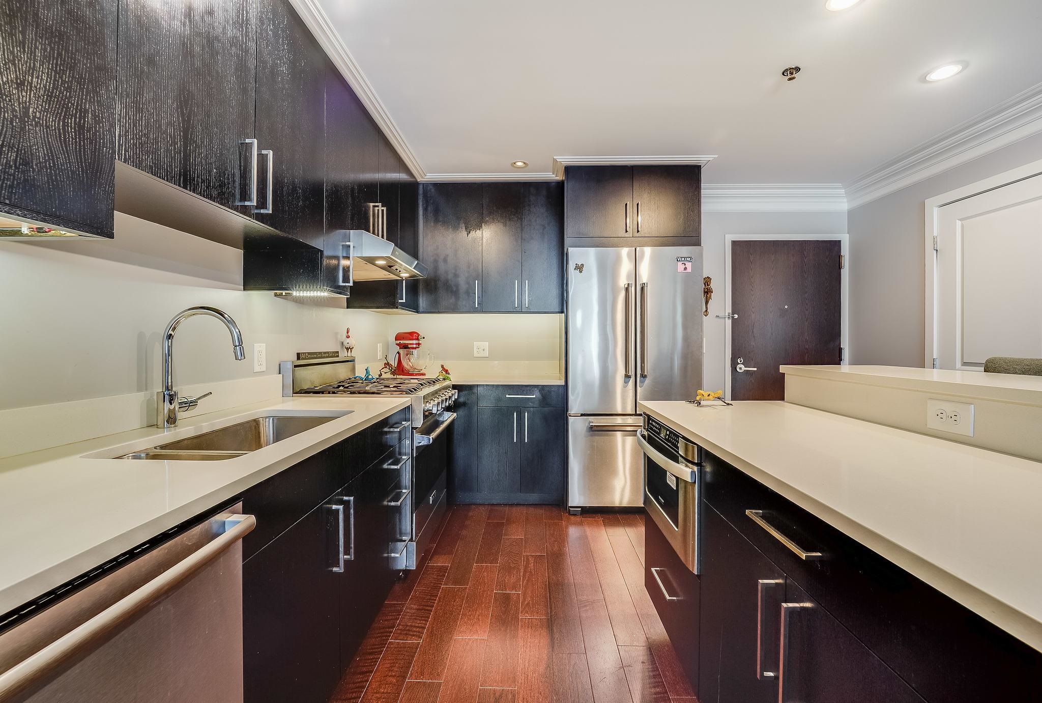 1100 Maxwell Lane, Unit 903 Hoboken, NJ 07030 - Photo 4 of 14 a kitchen with stainless steel appliances a sink stove and refrigerator