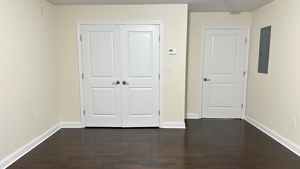 39 Fayette Street, Unit 102 Quincy, MA 02171 - Photo 16 of 24 an empty room with wooden floor