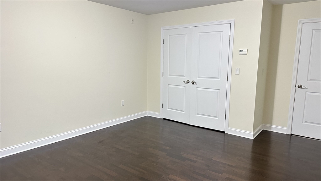 39 Fayette Street, Unit 102 Quincy, MA 02171 - Photo 17 of 24 an empty room with wooden floor