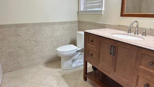 a bathroom with a sink toilet and vanity