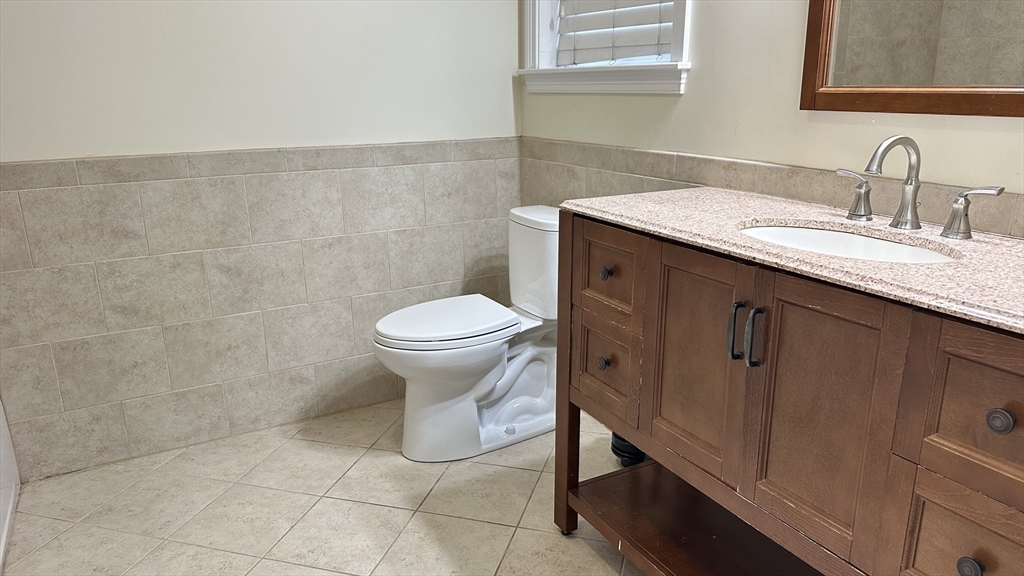 39 Fayette Street, Unit 102 Quincy, MA 02171 - Photo 20 of 24 a bathroom with a sink toilet and vanity
