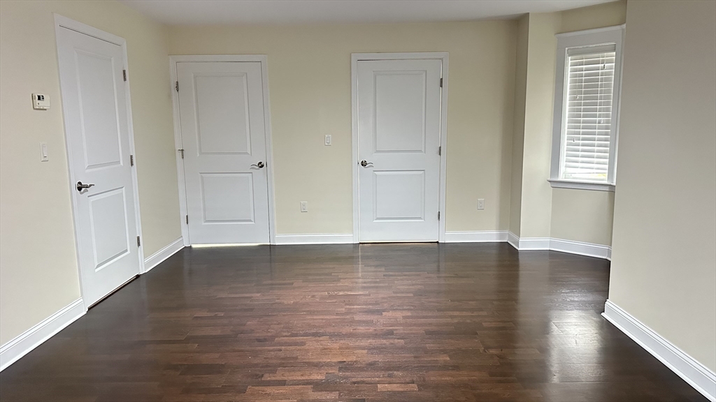 39 Fayette Street, Unit 102 Quincy, MA 02171 - Photo 24 of 24 a view of an empty room with wooden floor and a window