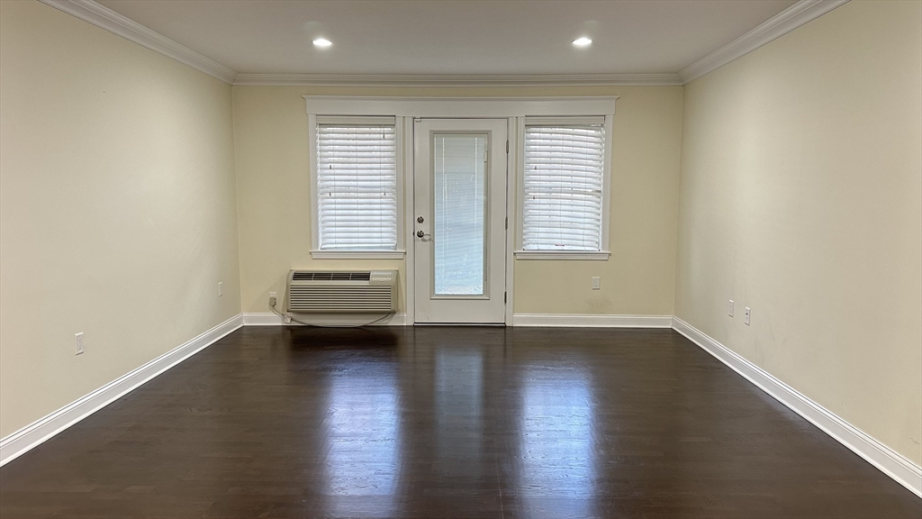 39 Fayette Street, Unit 102 Quincy, MA 02171 - Photo 3 of 24 an empty room with wooden floor and windows