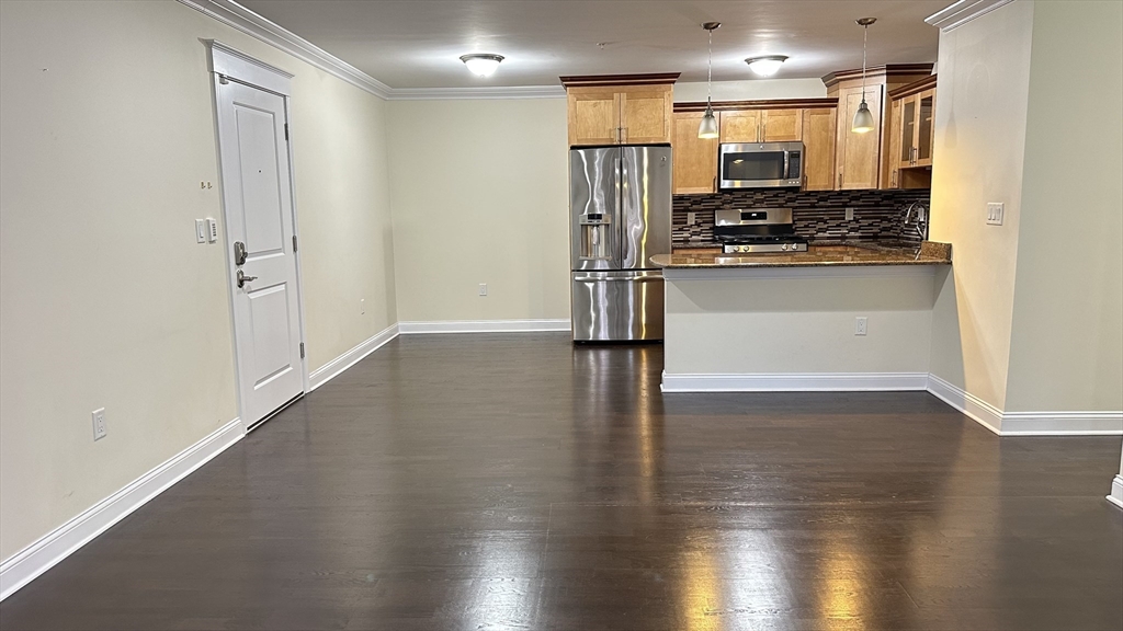 39 Fayette Street, Unit 102 Quincy, MA 02171 - Photo 9 of 24 a view of a kitchen with a refrigerator and a stove top oven