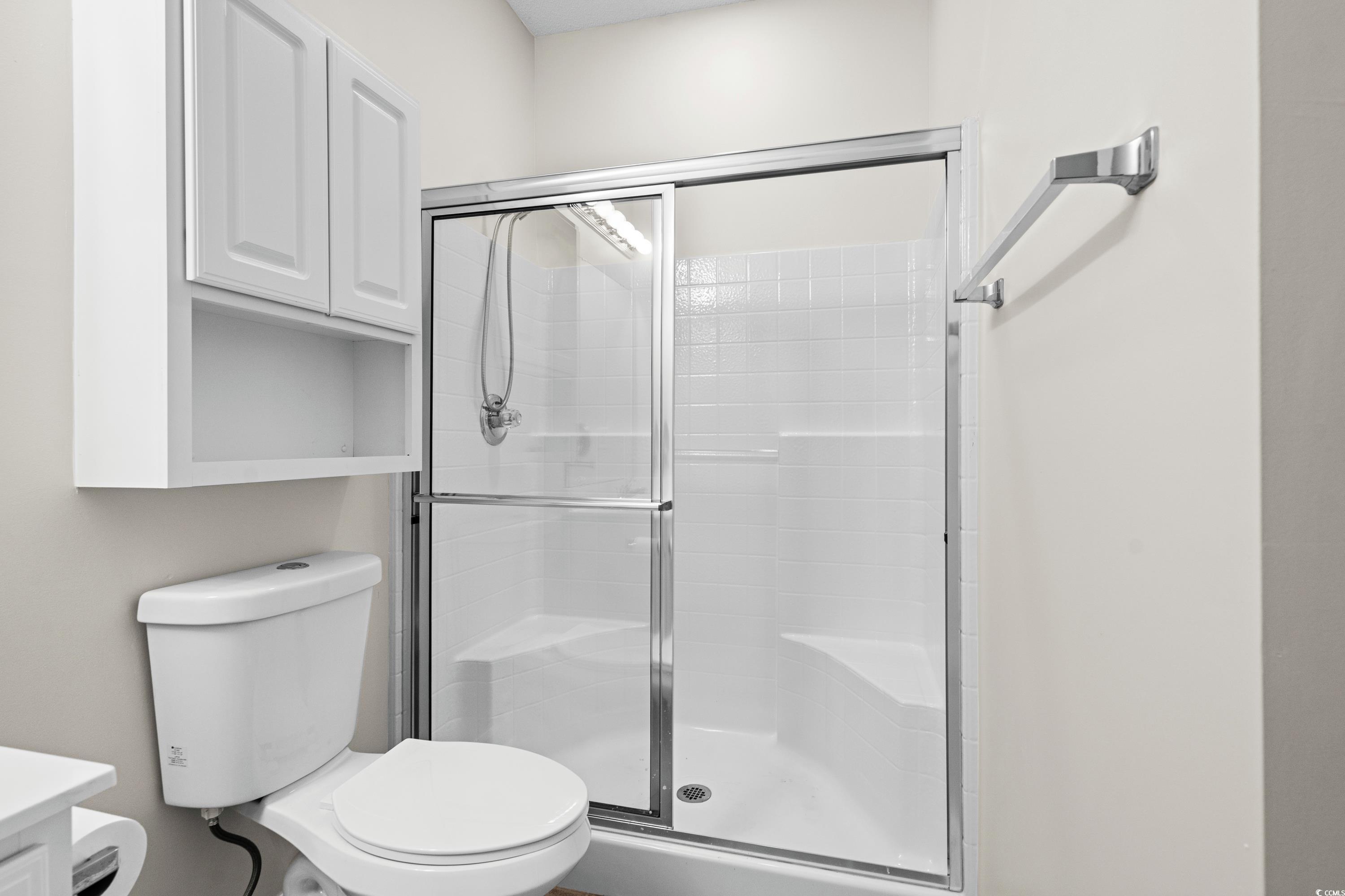 493 Shellbank Drive, Unit 2B Longs, SC 29568 - Photo 27 of 40 Bathroom featuring an enclosed shower, vanity, and