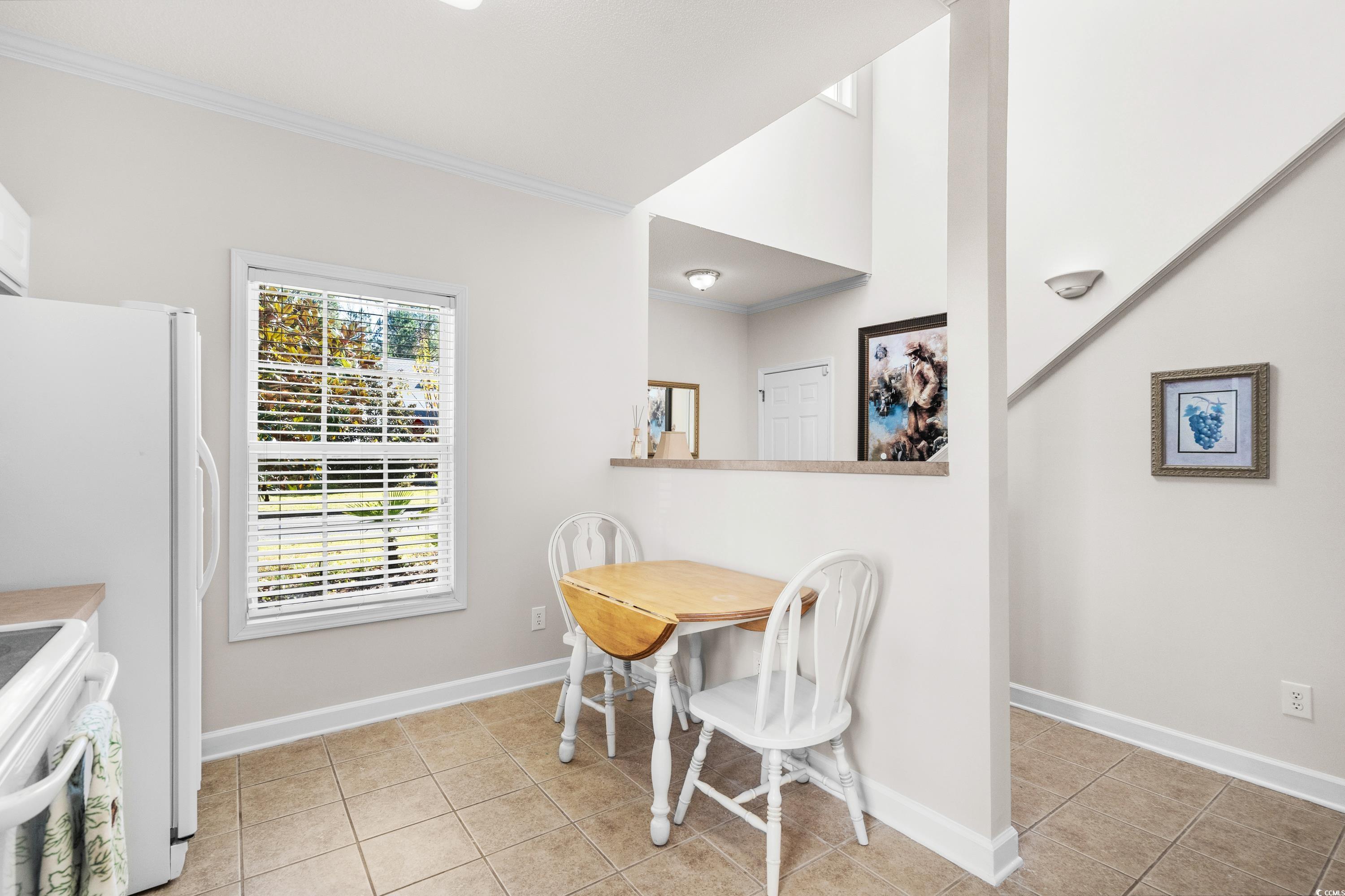 493 Shellbank Drive, Unit 2B Longs, SC 29568 - Photo 29 of 40 Tiled dining space featuring crown molding