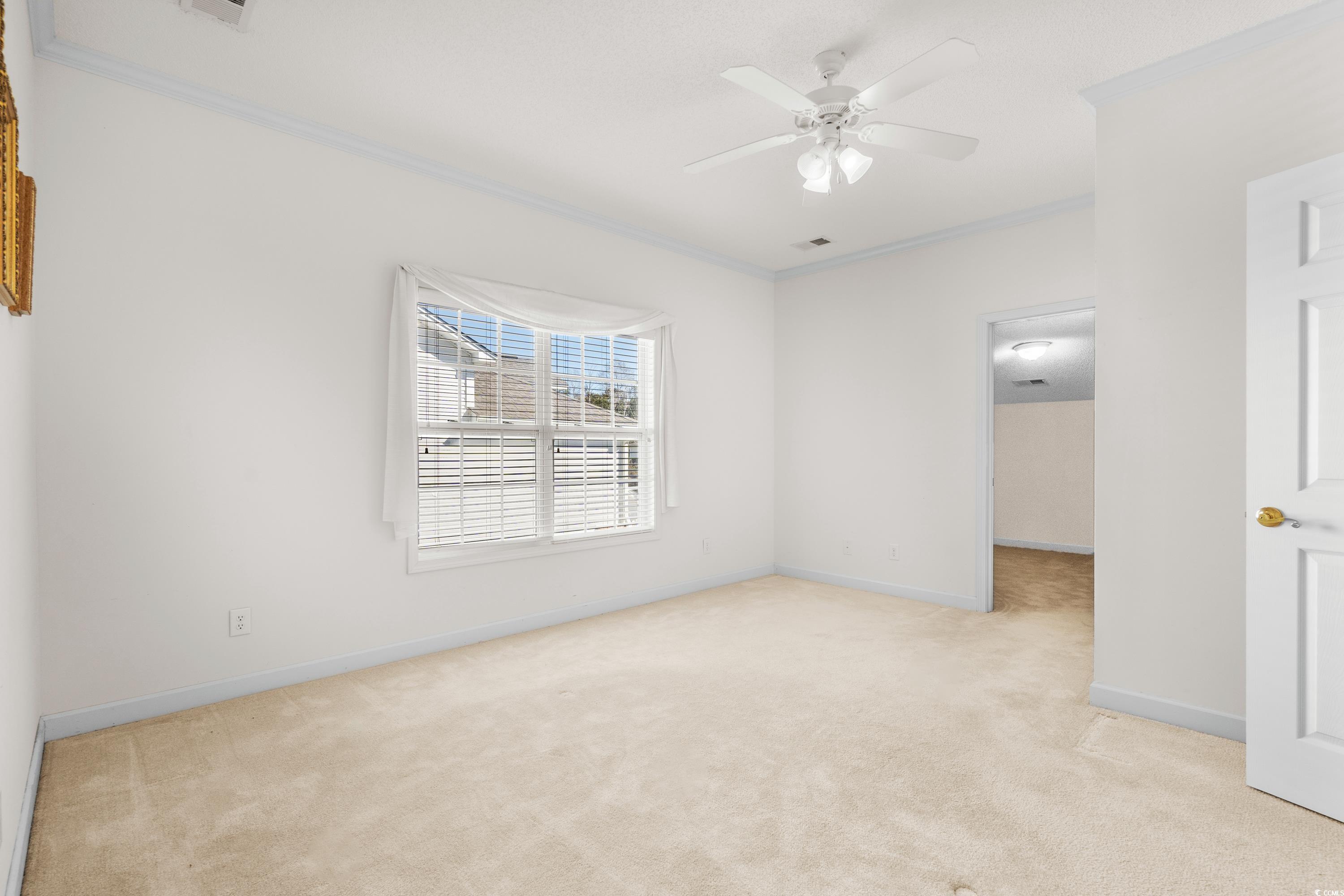 493 Shellbank Drive, Unit 2B Longs, SC 29568 - Photo 33 of 40 Carpeted spare room with crown molding and ceiling
