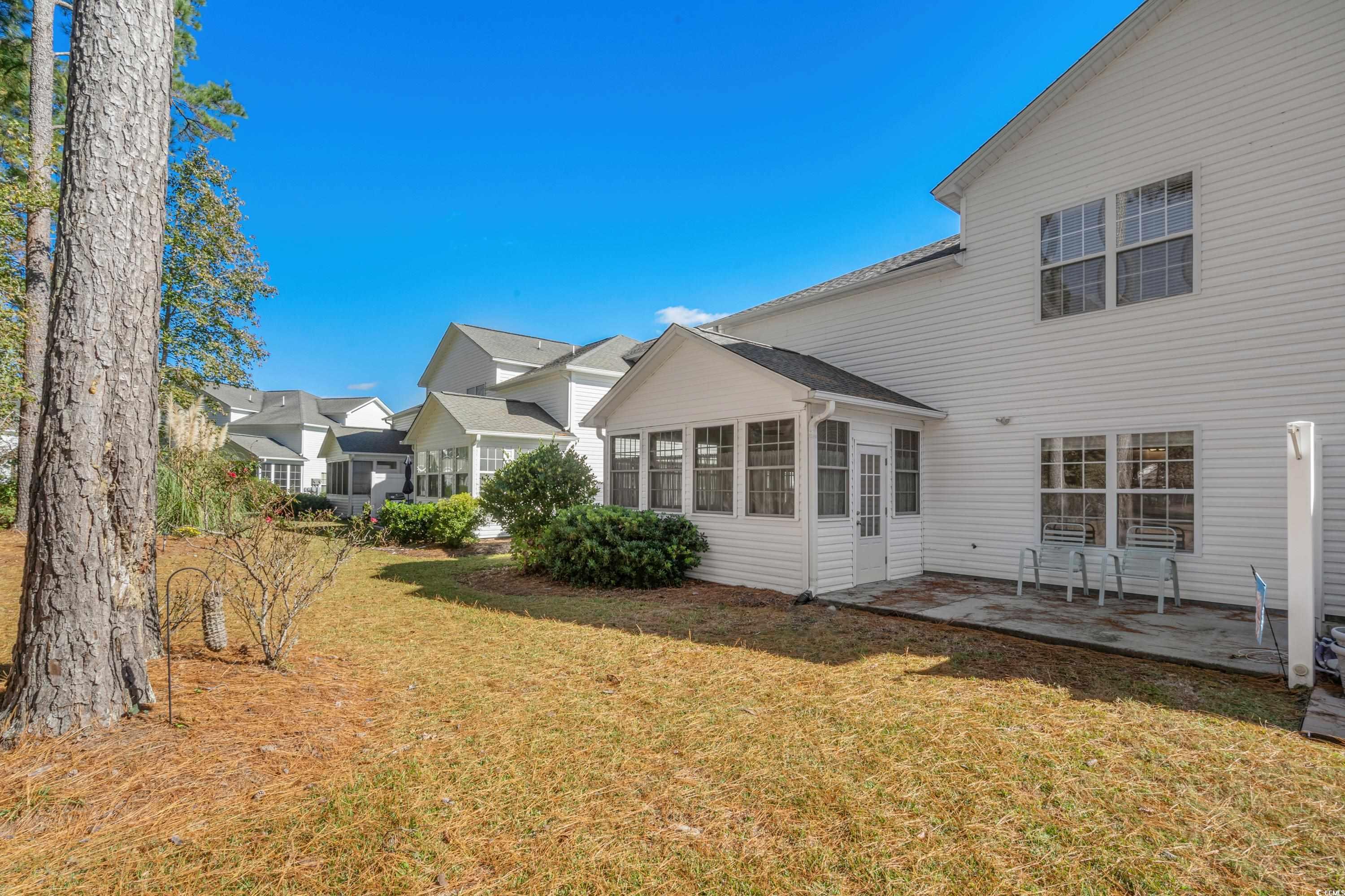 493 Shellbank Drive, Unit 2B Longs, SC 29568 - Photo 4 of 40 Rear view of house featuring a sunroom, a patio ar