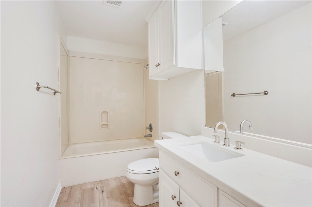 1604 Winfield Court Bryan, TX 77802 - Photo 11 of 14 a bathroom with a sink toilet vanity and shower