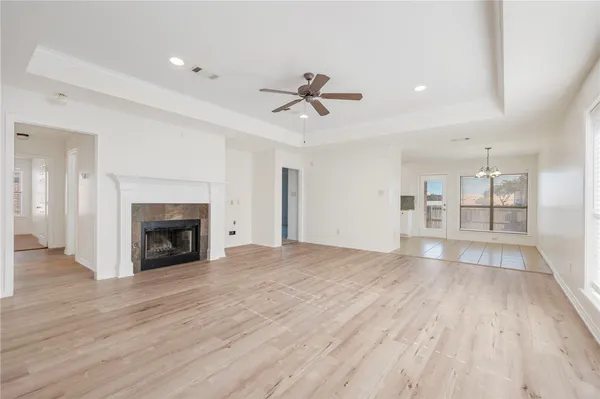 an empty room with windows and fireplace