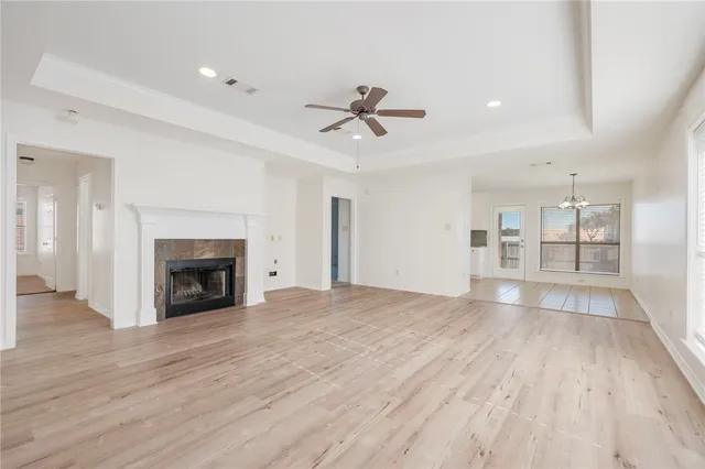 an empty room with windows and fireplace