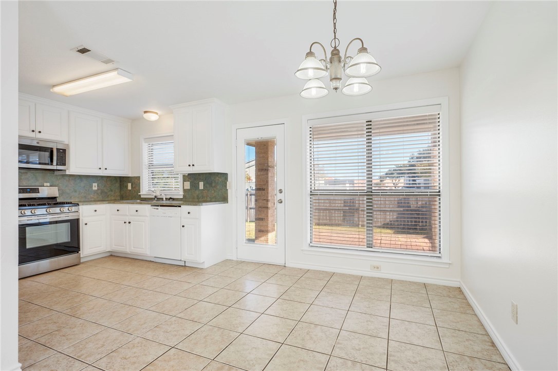 1604 Winfield Court Bryan, TX 77802 - Photo 5 of 14 a kitchen with a stove a refrigerator and cabinets