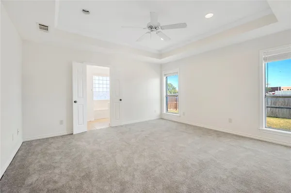 an empty room with windows and entrance