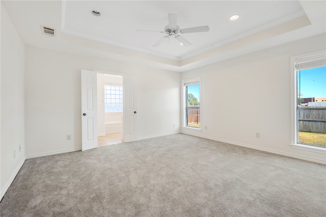 1604 Winfield Court Bryan, TX 77802 - Photo 6 of 14 an empty room with windows and entrance