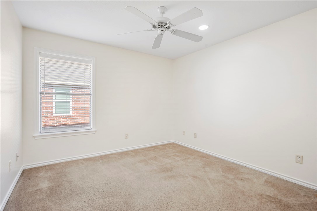 1604 Winfield Court Bryan, TX 77802 - Photo 9 of 14 an empty room with a window and a fan