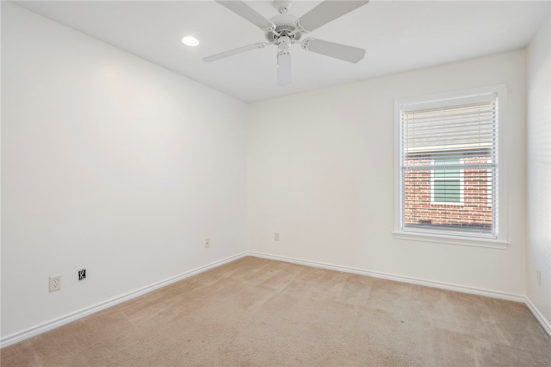 1604 Winfield Court Bryan, TX 77802 - Photo 10 of 14 an empty room with a window and a fan