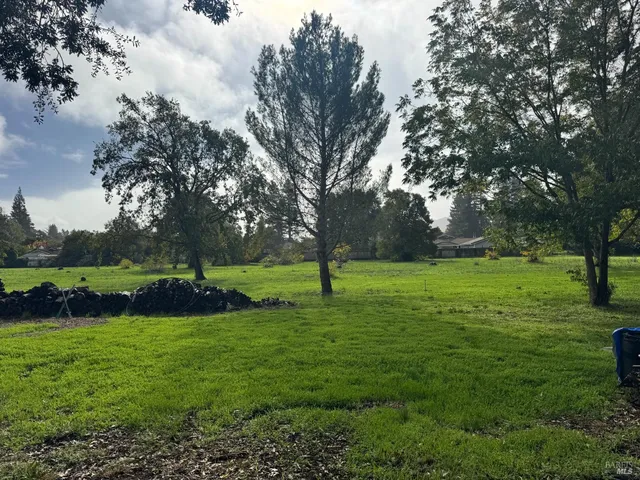 a view of a house with backyard sitting area and garden