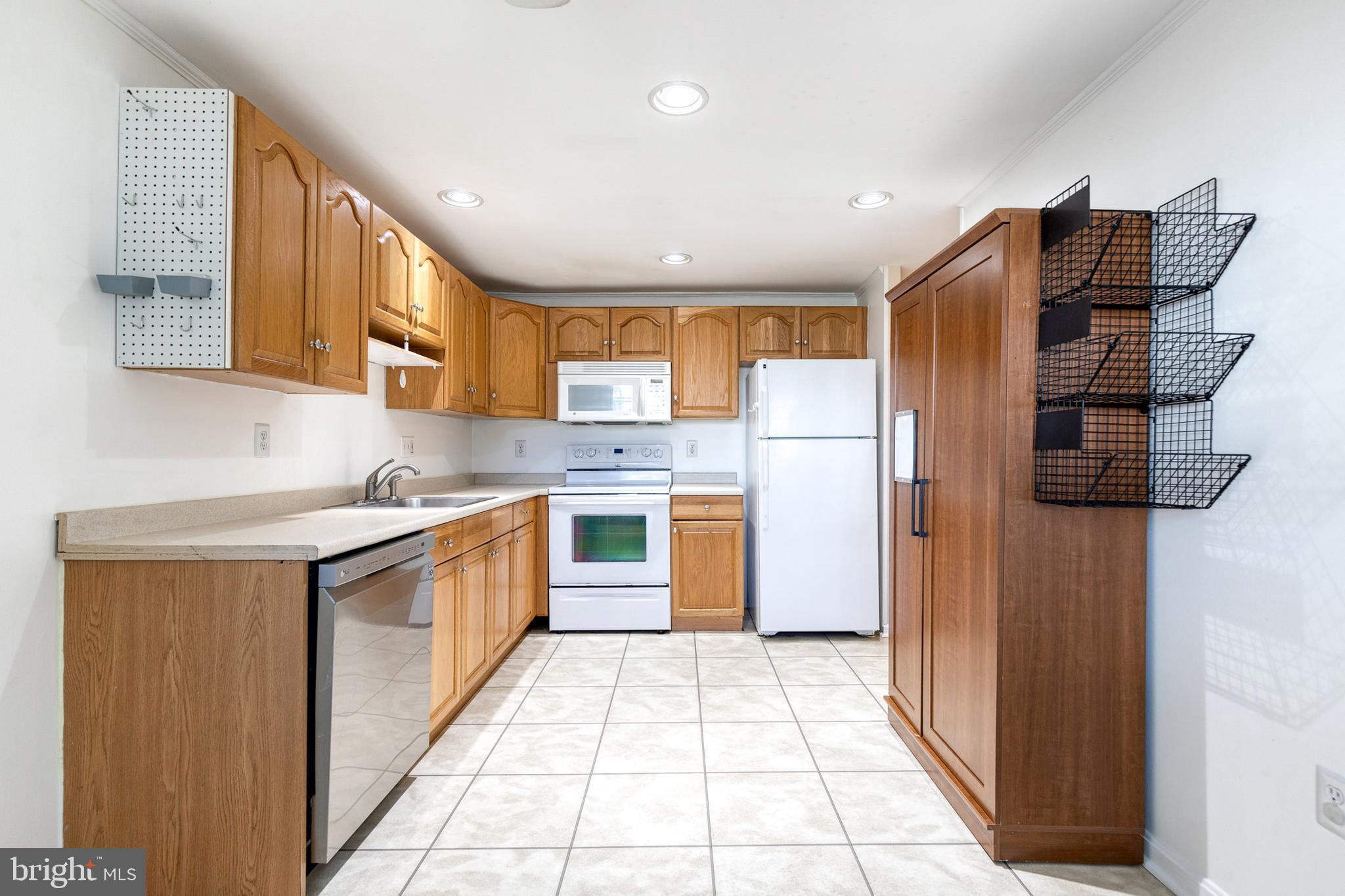 2652 April Dawn Way Gambrills, MD 21054 - Photo 11 of 26 a kitchen with stainless steel appliances granite countertop a refrigerator a sink dishwasher a stove with wooden cabinets