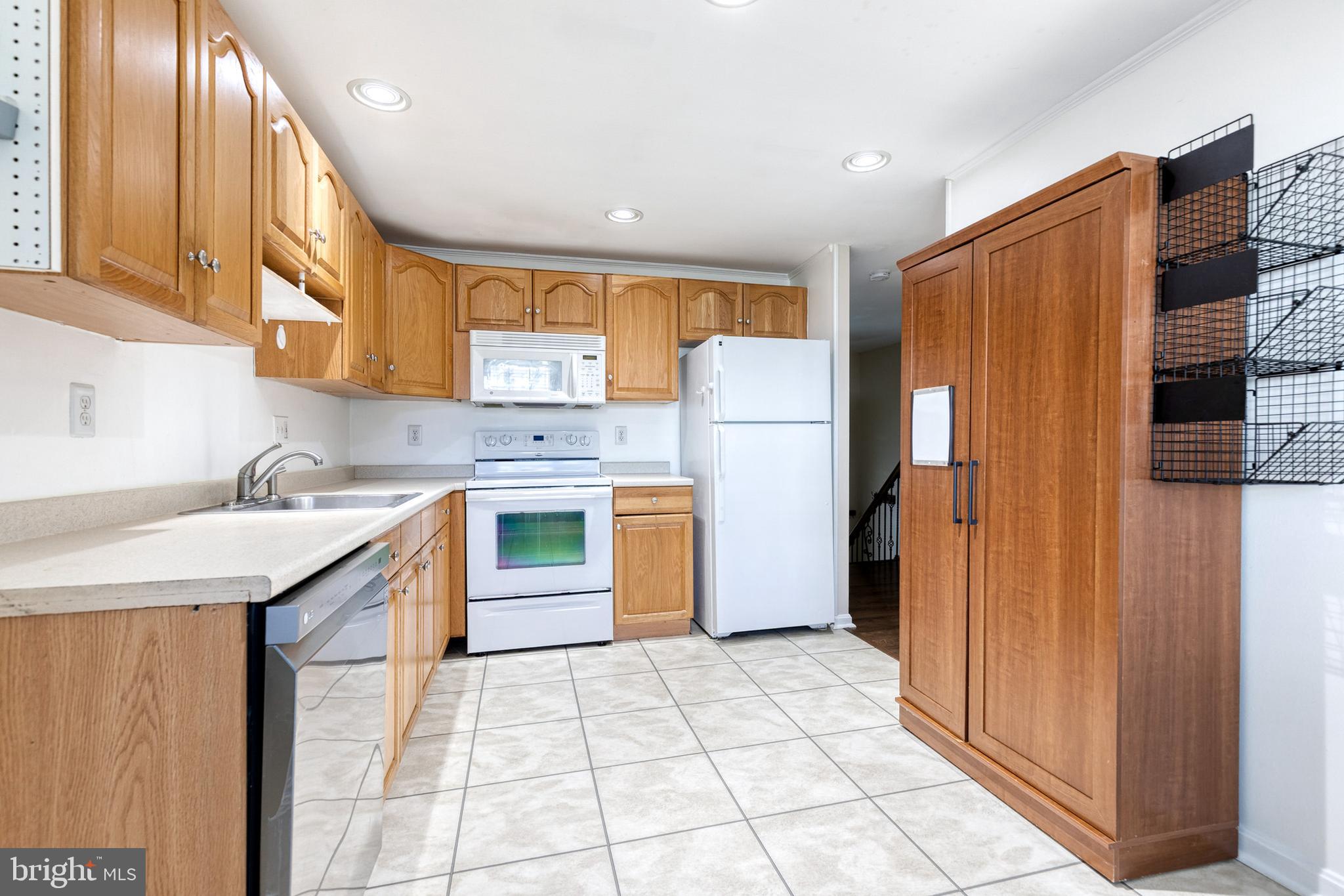 2652 April Dawn Way Gambrills, MD 21054 - Photo 12 of 26 a kitchen with a refrigerator sink stove and cabinets
