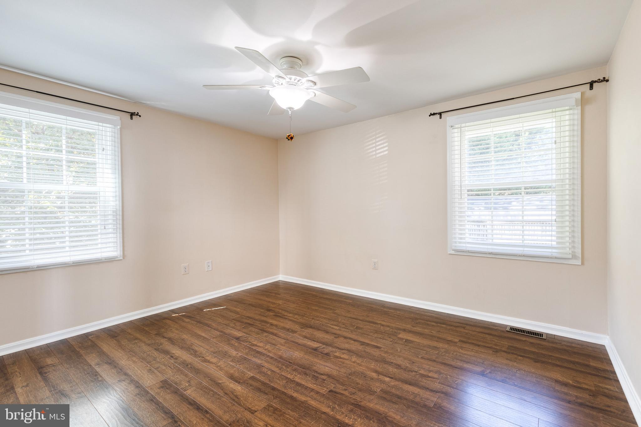 2652 April Dawn Way Gambrills, MD 21054 - Photo 13 of 26 a view of an empty room with wooden floor and a window