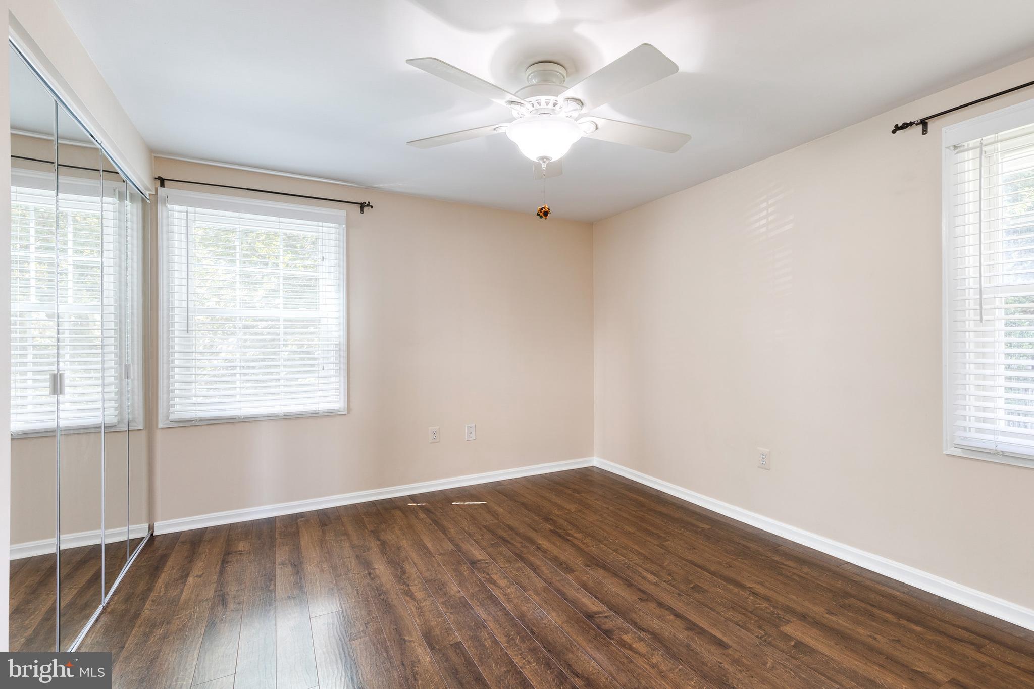 2652 April Dawn Way Gambrills, MD 21054 - Photo 14 of 26 an empty room with wooden floor and windows
