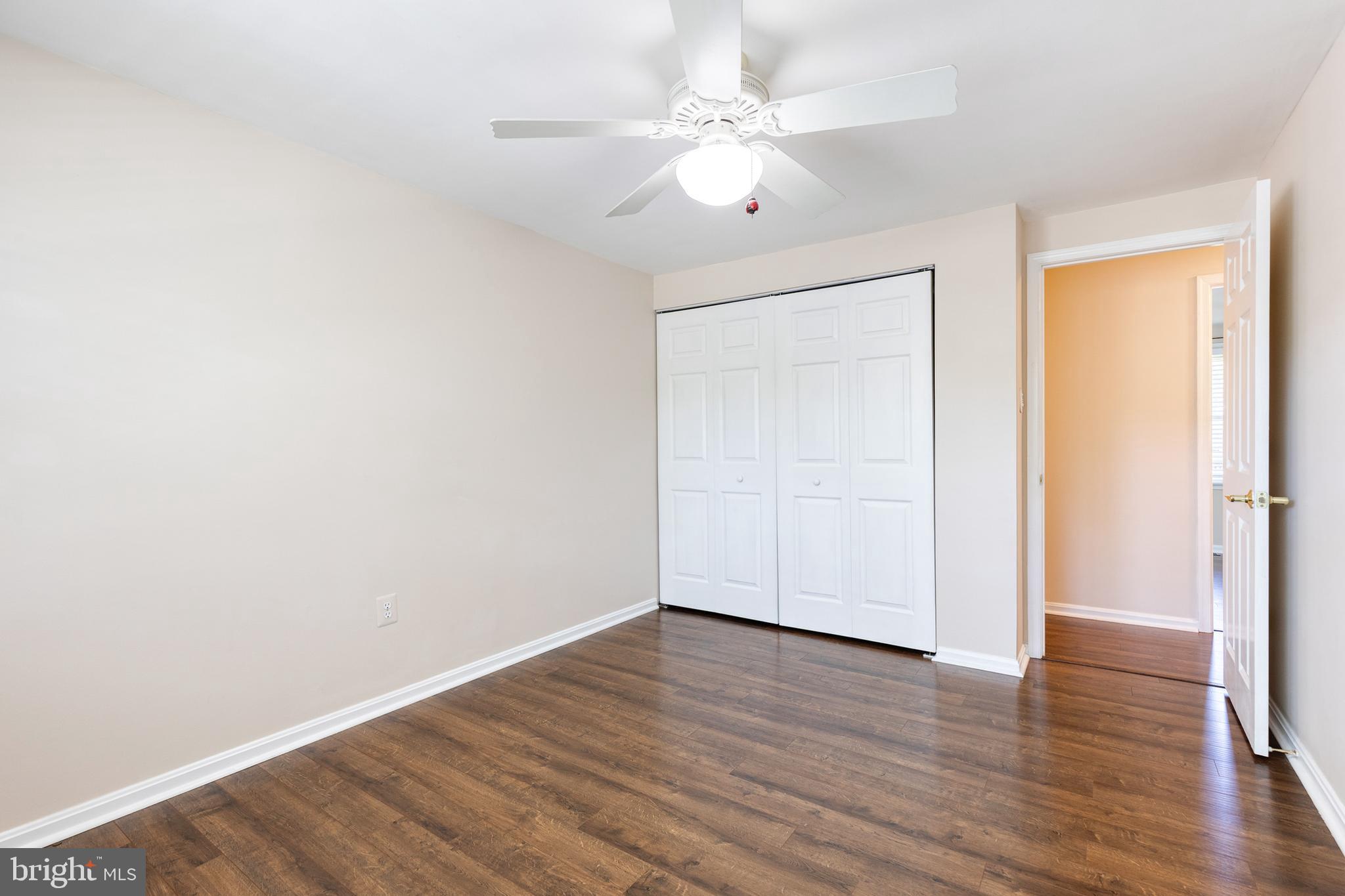 2652 April Dawn Way Gambrills, MD 21054 - Photo 16 of 26 an empty room with wooden floor and ceiling fan