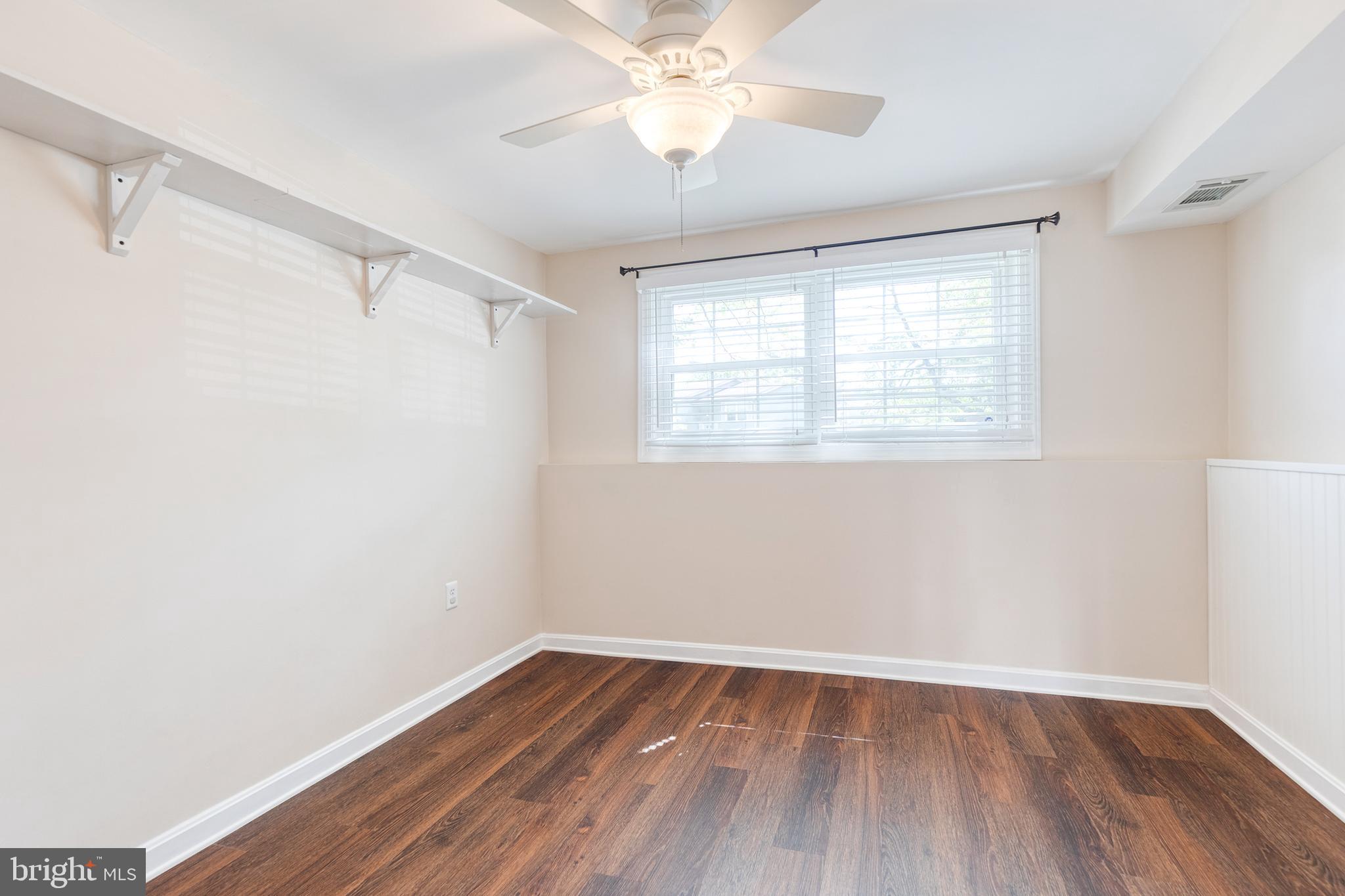 2652 April Dawn Way Gambrills, MD 21054 - Photo 20 of 26 a view of an empty room with wooden floor and a window