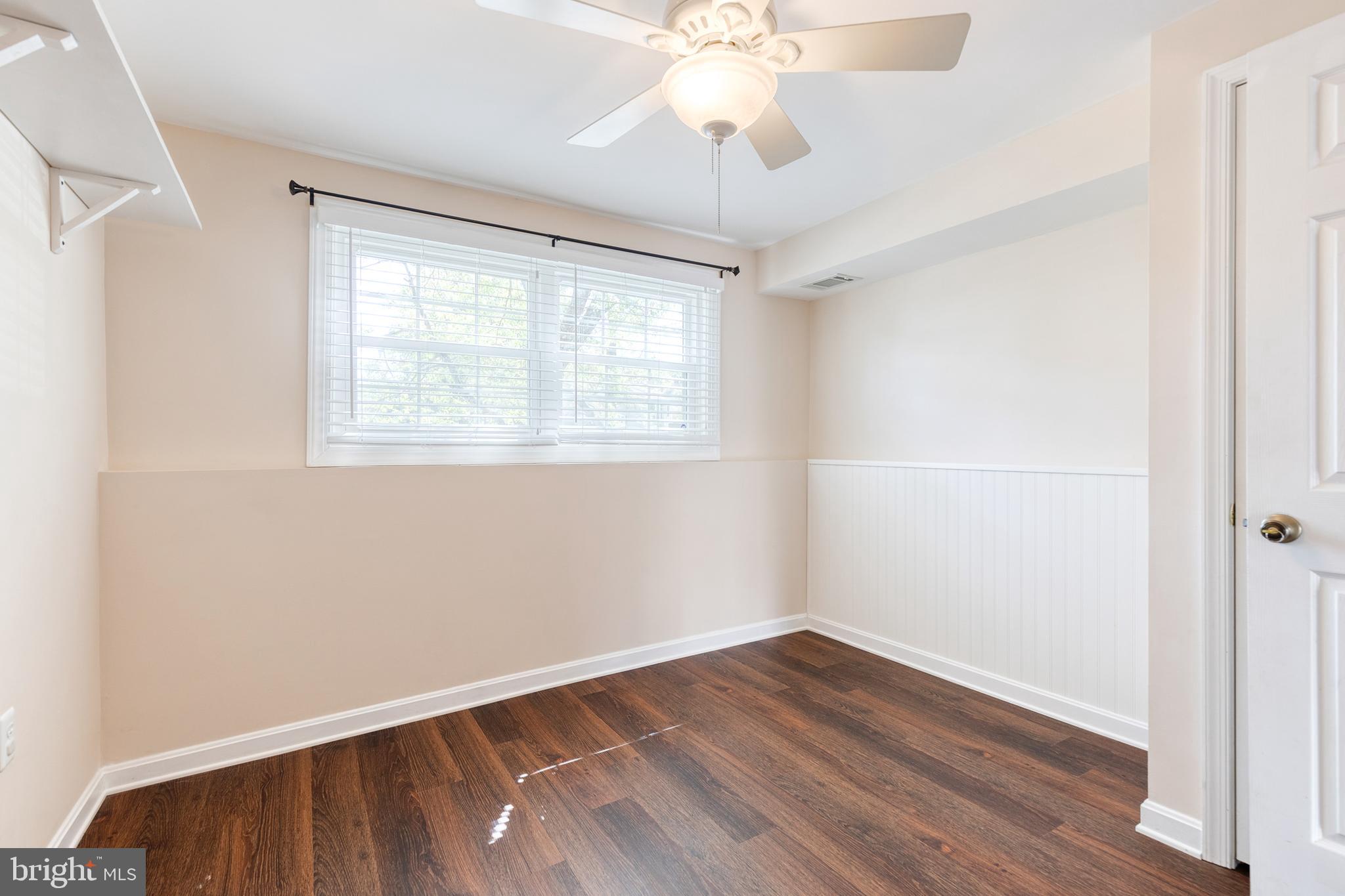 2652 April Dawn Way Gambrills, MD 21054 - Photo 21 of 26 a view of an empty room with wooden floor and a window