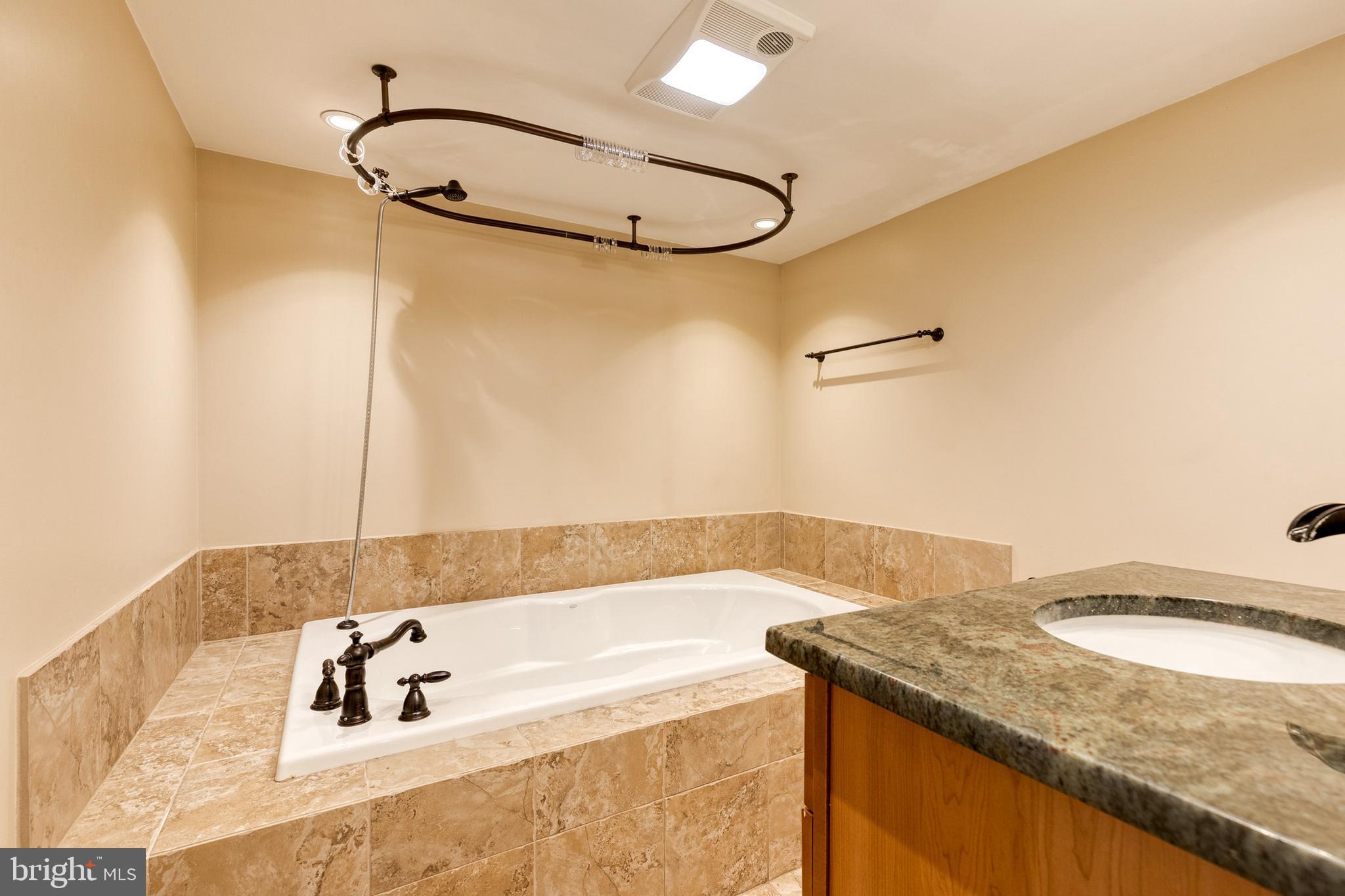 2652 April Dawn Way Gambrills, MD 21054 - Photo 22 of 26 a bathroom with a granite countertop sink a mirror and shower