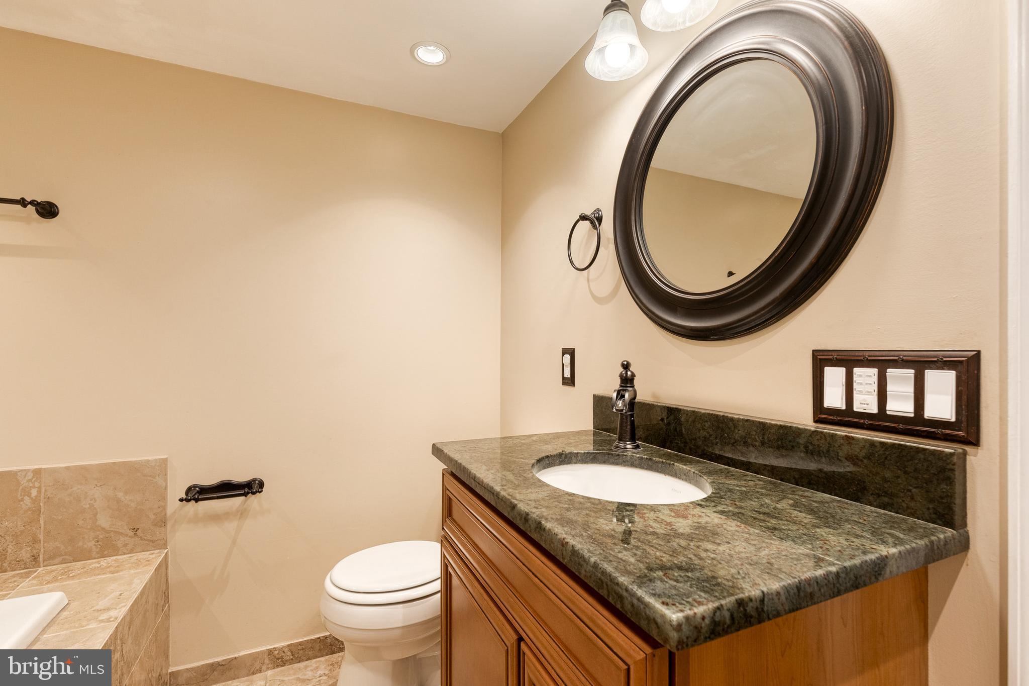 2652 April Dawn Way Gambrills, MD 21054 - Photo 23 of 26 a bathroom with a granite countertop sink and a mirror