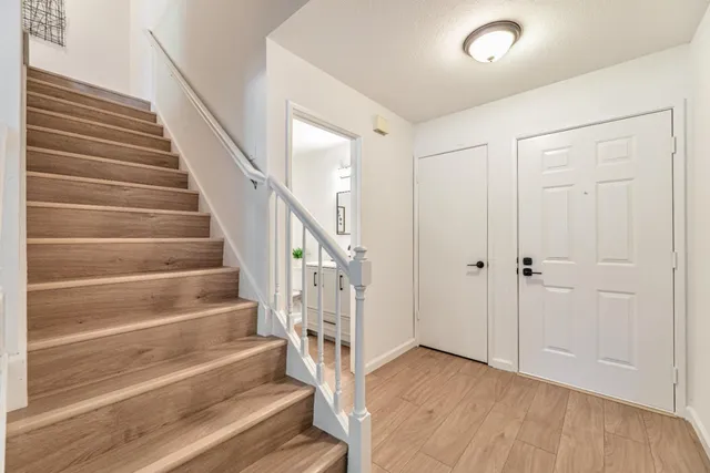 a view of entryway with wooden floor and stairs