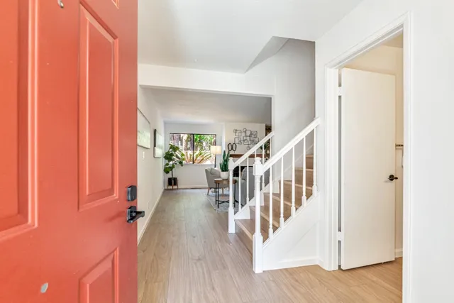 a view of entryway with wooden floor and stairs