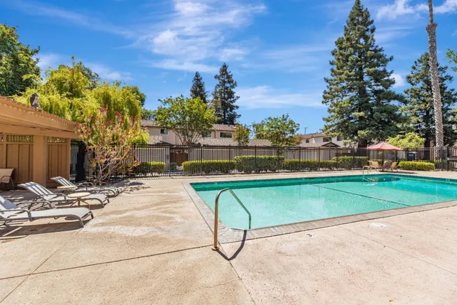 a view of swimming pool with outdoor seating and plants