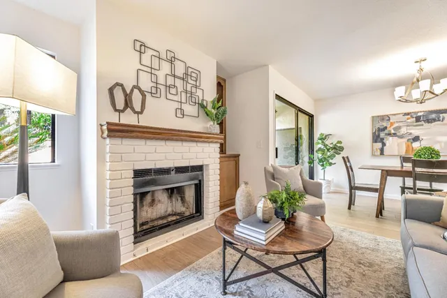 a living room with furniture and a fireplace