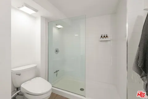 a view of balcony with a large window and wooden floor