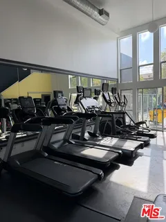 a view of a patio with table and chairs under an umbrella