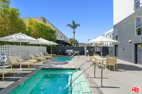 a front view of a building with cars parked