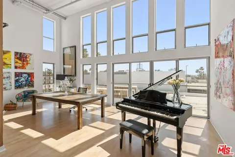 a living room with a table and a potted plant