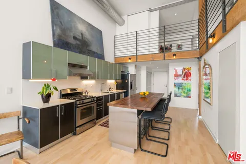a kitchen with sink a stove and cabinets